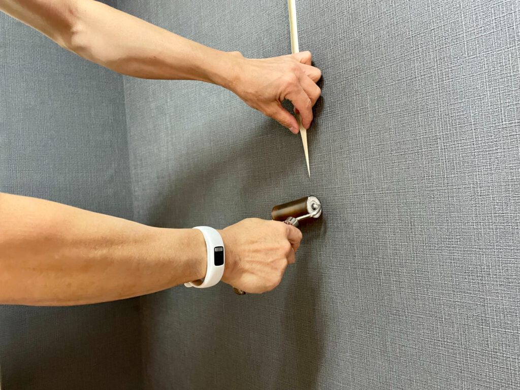 クロスを貼る作業員